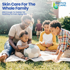A family of four sits on a white blanket on a grassy lawn, playing with a soccer ball in a sunny backyard. The image features marketing text on the top left reading 'Skin Care For The Whole Family' and the 'Earth's Care' logo in the top right corner.