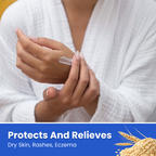 A person in a white textured robe applies a white cream to their hand. A blue banner at the bottom reads 'Protects And Relieves Dry Skin, Rashes, Eczema' with a wheat graphic.