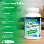 A bottle of De La Cruz Sodium Bicarbonate USP oral powder antacid shown on a green promotional background with text instructions on how to use the product.
