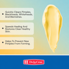 A promotional graphic for De La Cruz skincare showing a cream-colored product smear on a light blue-to-yellow gradient background with three bullet points describing skin benefits, and the De La Cruz logo at the bottom.